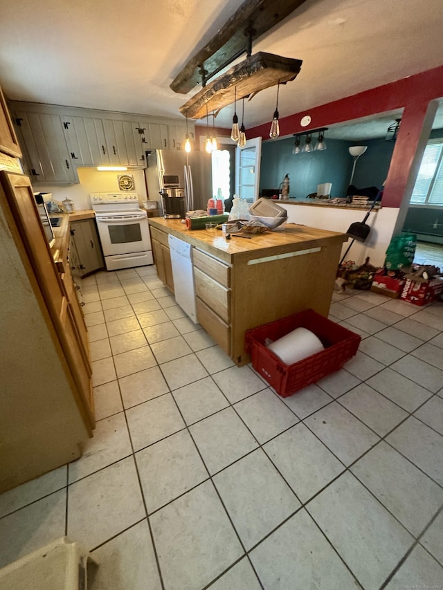 kitchen with white appliances, light tile patterned flooring, decorative light fixtures, and a kitchen island