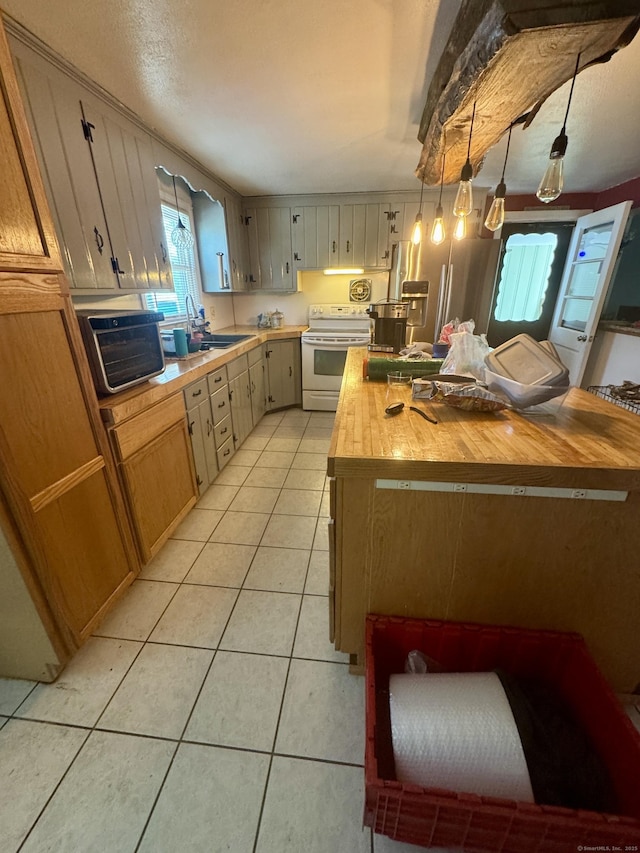 kitchen with decorative light fixtures, light tile patterned floors, a sink, electric stove, and butcher block countertops