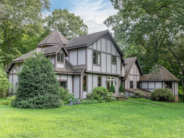 rear view of property with a yard