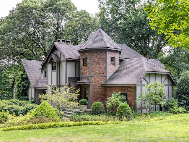 english style home featuring a front lawn