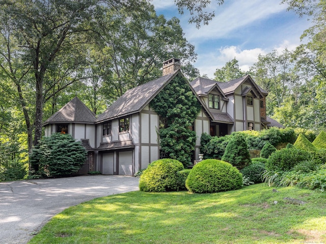 view of side of property with a yard and a garage