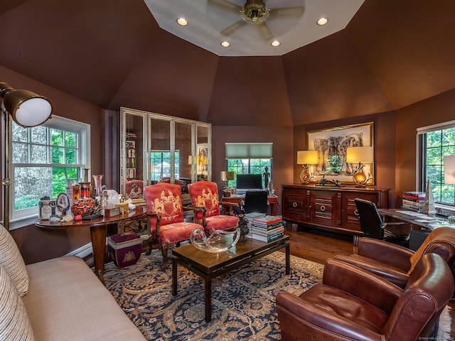 living room featuring wood-type flooring, high vaulted ceiling, and ceiling fan