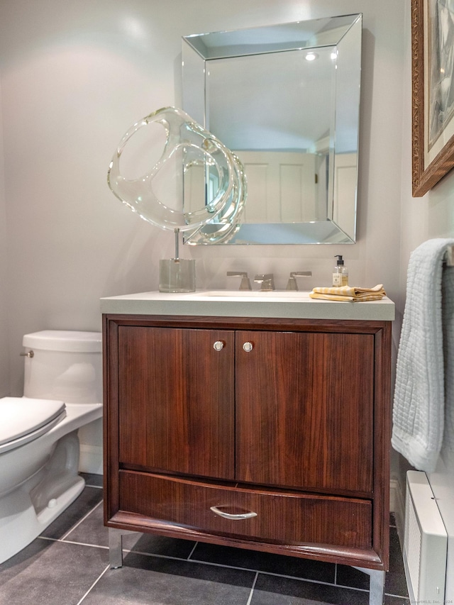 bathroom featuring tile patterned flooring, vanity, and toilet