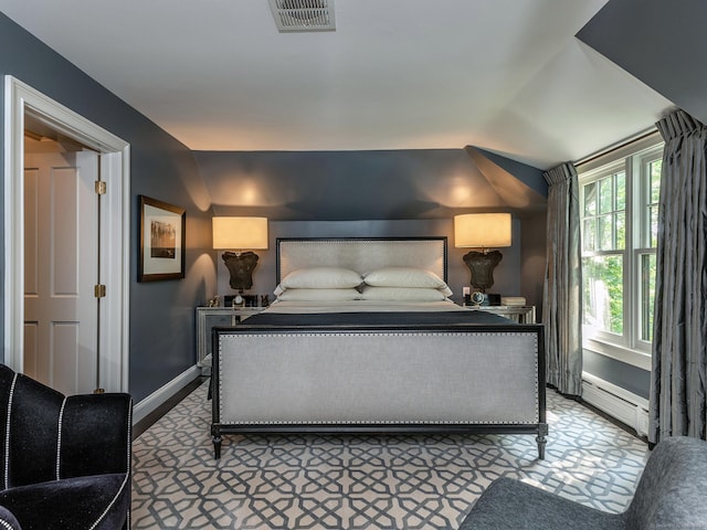 carpeted bedroom featuring a baseboard heating unit