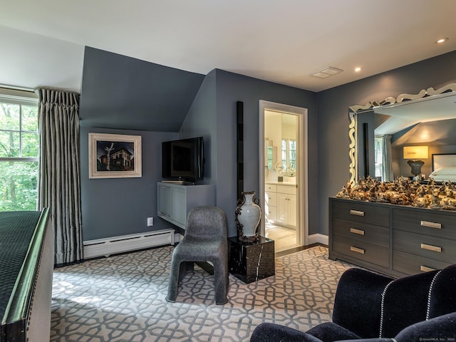 interior space with connected bathroom, a baseboard radiator, and vaulted ceiling