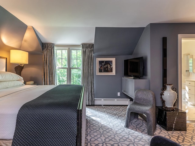 bedroom with lofted ceiling, ensuite bath, and baseboard heating