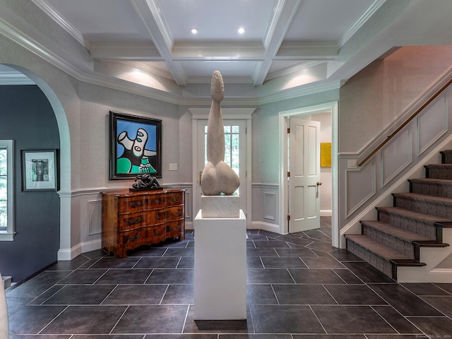 tiled entrance foyer with beamed ceiling, ornamental molding, and coffered ceiling