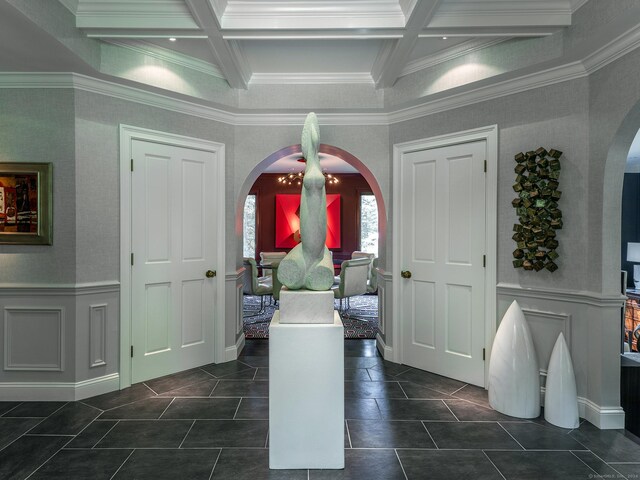 tiled foyer featuring coffered ceiling, crown molding, and beamed ceiling