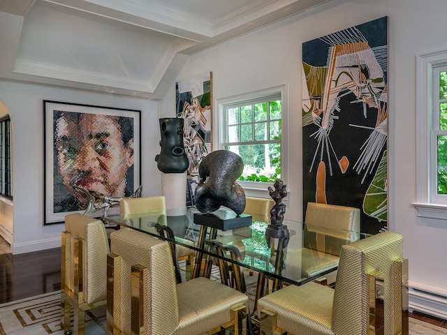 dining area featuring crown molding, a baseboard radiator, and wood-type flooring