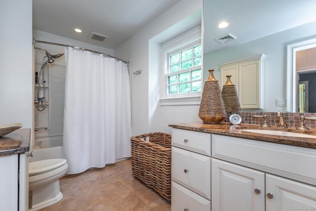 full bathroom with tile patterned floors, toilet, vanity, shower / bath combo with shower curtain, and backsplash