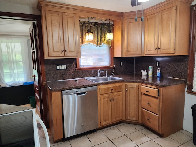 kitchen featuring dishwasher, light tile patterned flooring, tasteful backsplash, and sink