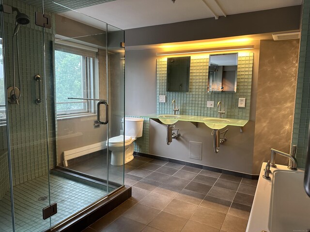 bathroom with vanity, toilet, tile patterned floors, and an enclosed shower