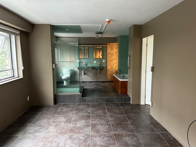 hall featuring dark tile patterned floors