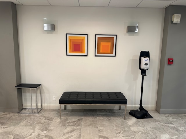 interior space featuring a drop ceiling and light tile patterned flooring