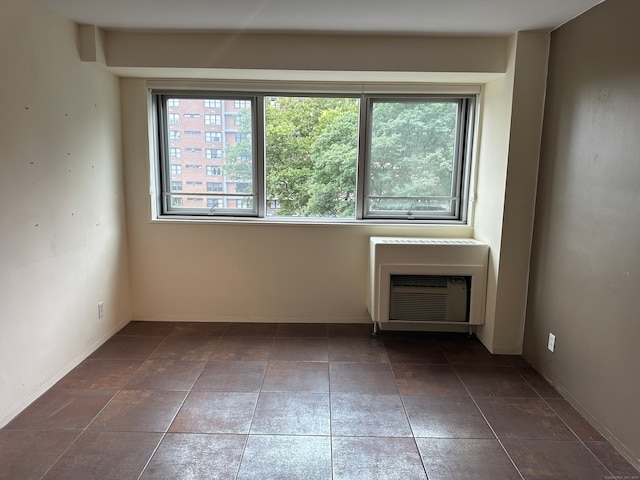 tiled spare room with heating unit