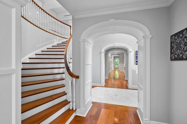 entryway featuring hardwood / wood-style floors and crown molding