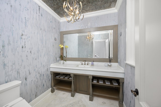 bathroom with ornamental molding, a notable chandelier, sink, and toilet