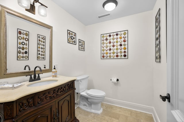 bathroom with tile patterned floors, vanity, and toilet