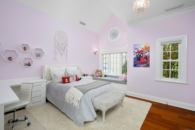 bedroom with hardwood / wood-style flooring, lofted ceiling, multiple windows, and a notable chandelier