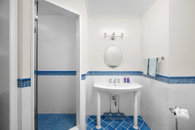 bathroom featuring tile patterned flooring, a tile shower, and tile walls