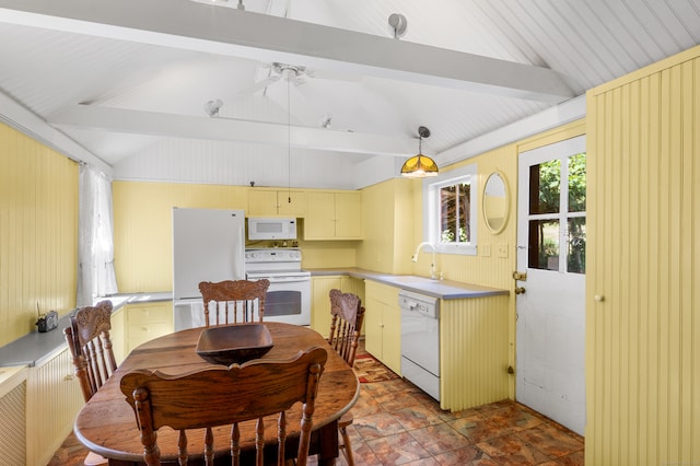 dining room featuring ceiling fan, sink, and vaulted ceiling with beams