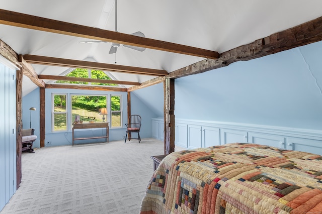 carpeted bedroom with lofted ceiling with beams and ceiling fan