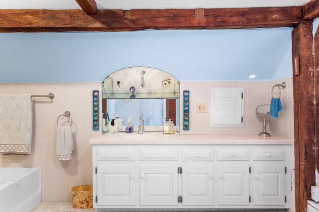 bathroom with vanity, tile walls, and a washtub