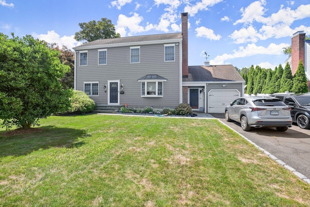 colonial house with a front lawn and a garage