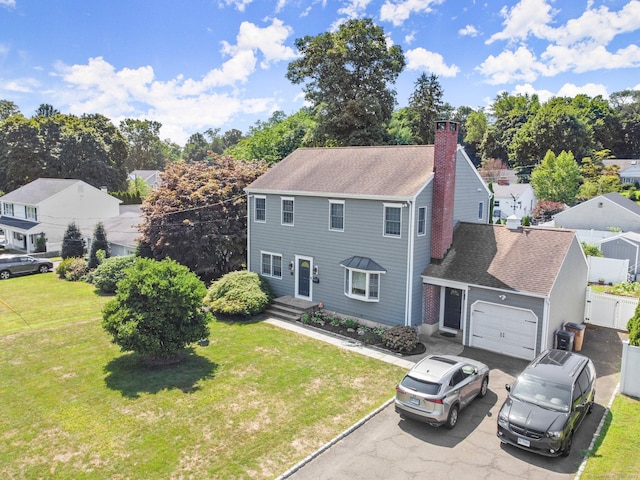 view of front of home featuring a garage and a front lawn