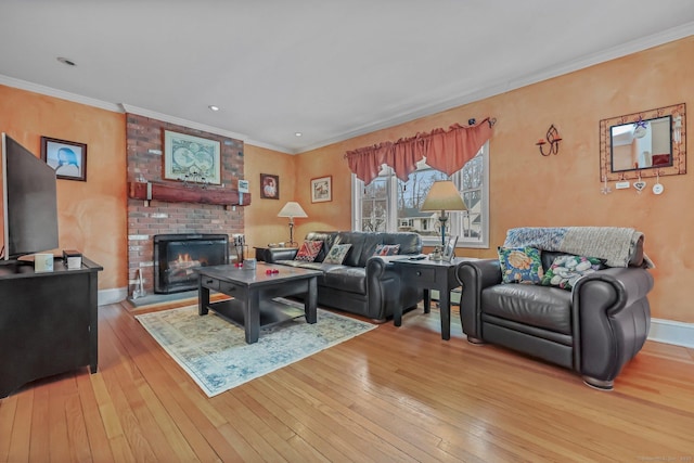 living room with crown molding, hardwood / wood-style floors, and a brick fireplace