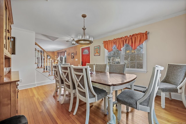 dining area with light wood-type flooring and ornamental molding