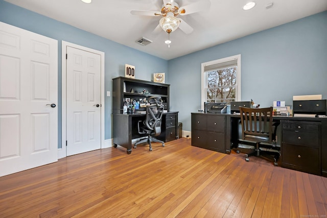 home office with ceiling fan and hardwood / wood-style floors