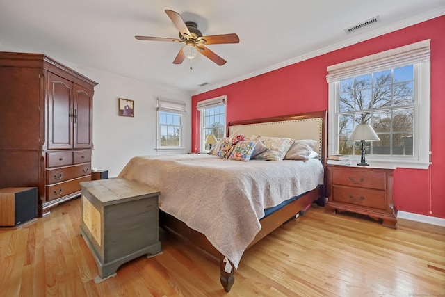 bedroom with light hardwood / wood-style flooring and ceiling fan