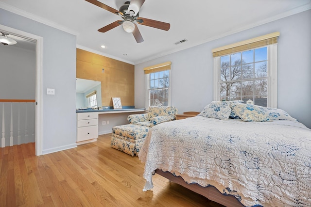 bedroom featuring ceiling fan, light hardwood / wood-style floors, and ornamental molding