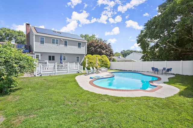 view of pool with a yard and a wooden deck