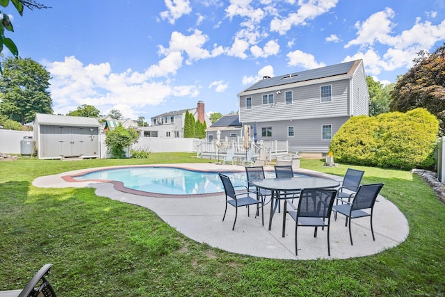 view of pool featuring a patio area, a shed, and a yard