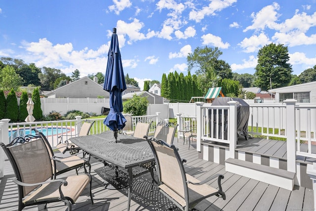 wooden terrace with a fenced in pool