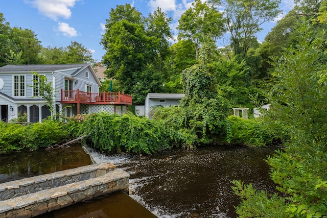 view of yard featuring a deck with water view