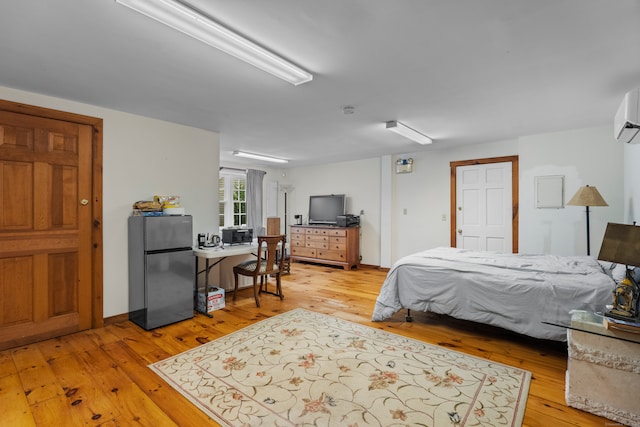 bedroom featuring hardwood / wood-style flooring and stainless steel refrigerator