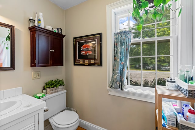 bathroom featuring vanity and toilet