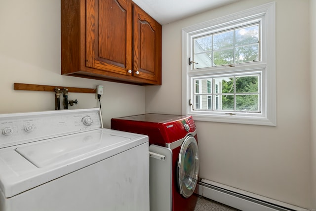 laundry area featuring a baseboard heating unit, cabinets, and washing machine and dryer