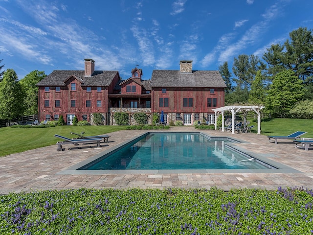 outdoor pool with a yard, a patio, and a pergola