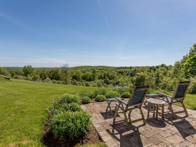view of patio / terrace featuring a forest view