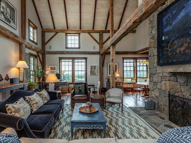 living room with a stone fireplace, wood-type flooring, high vaulted ceiling, wooden ceiling, and beam ceiling