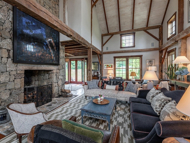 living room with a stone fireplace, beam ceiling, and high vaulted ceiling