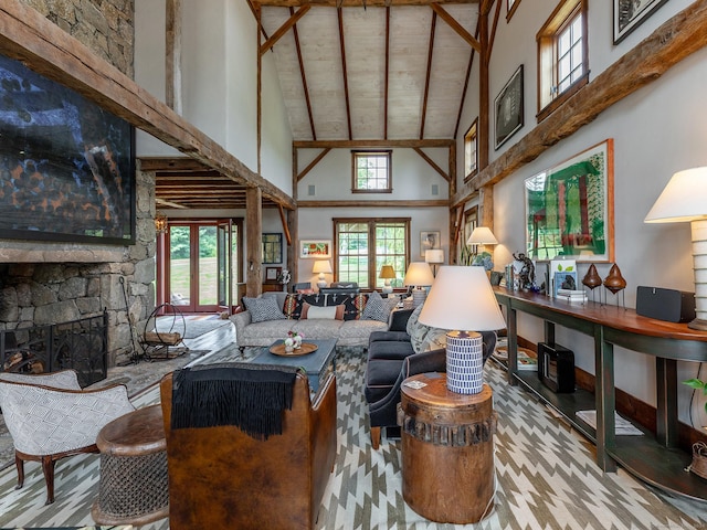 living area with a fireplace, beam ceiling, and high vaulted ceiling