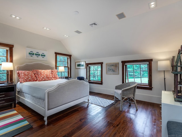 bedroom with baseboards, vaulted ceiling, visible vents, and dark wood-type flooring