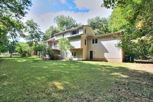 rear view of house featuring a yard