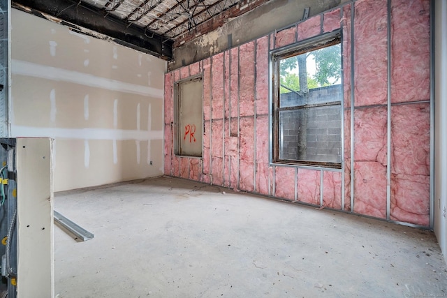 spare room with unfinished concrete flooring