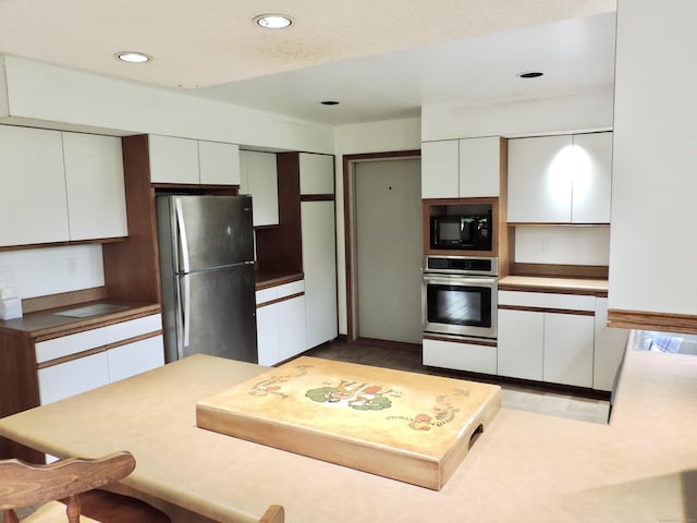 181 Scotland Rd, Sprague, CT 06330 - kitchen with stainless steel appliances, white cabinets, recessed lighting, and a peninsula